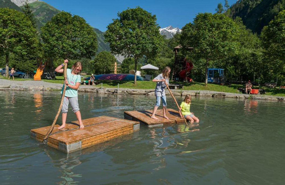 Spelende kinderen in het water bij Eienwäldli Camping in Zwitserland tussen de Alpen van het Berner Oberland